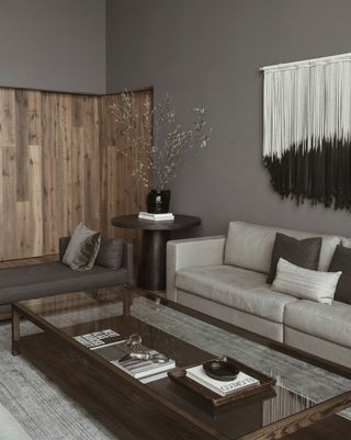 A living room with fabric wall hanging