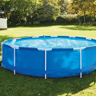 blue swimming pool in garden area