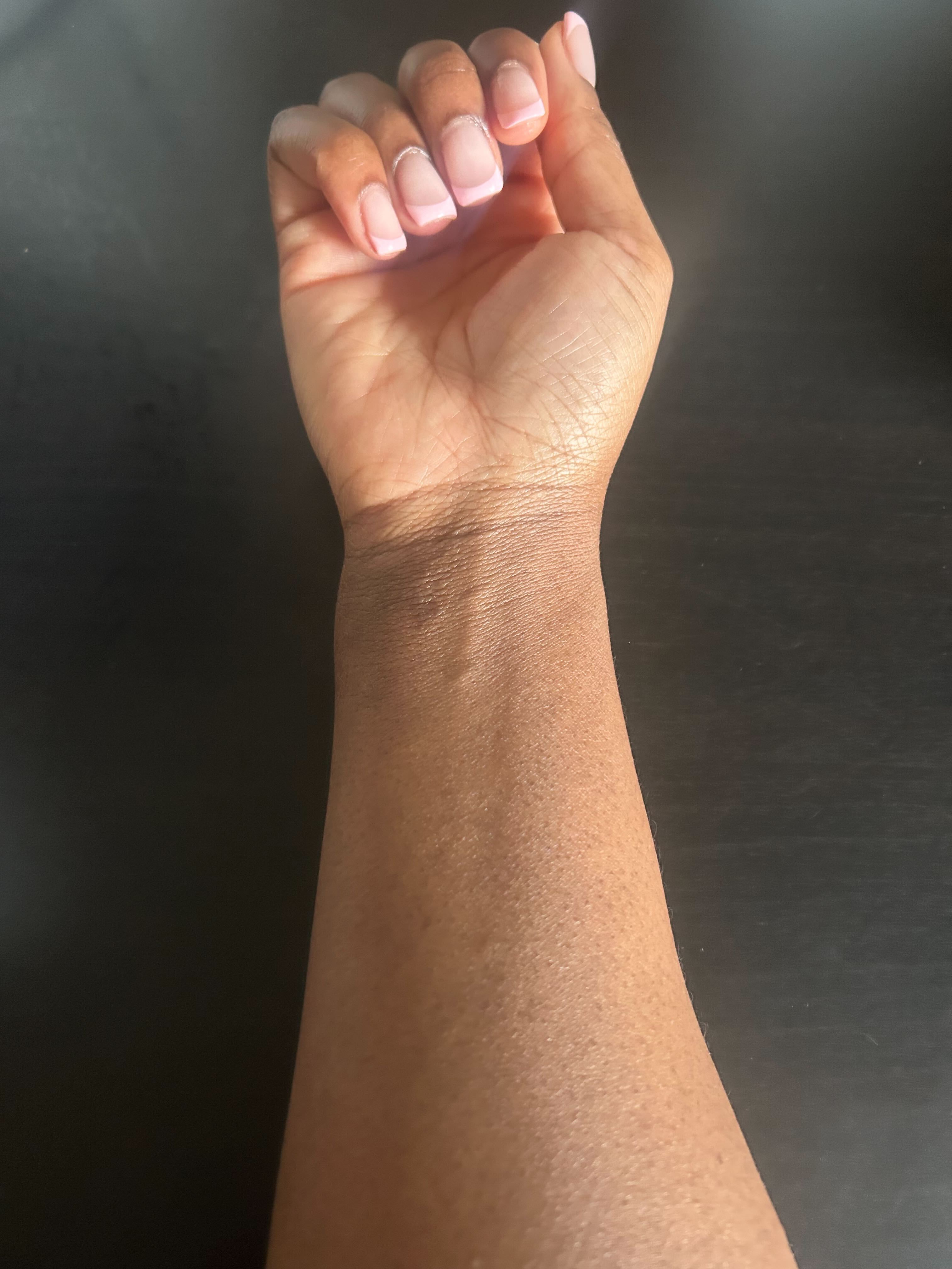 Brittany's arm before testing Bondi Sands tan in Caramel