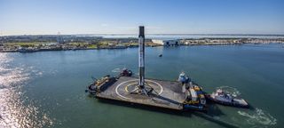 A SpaceX Falcon 9 rocket booster makes a triumphant return to Port Canaveral, Florida on Dec. 7, 2019, two days after launching a Dragon cargo ship for NASA on the CRS-19 mission.