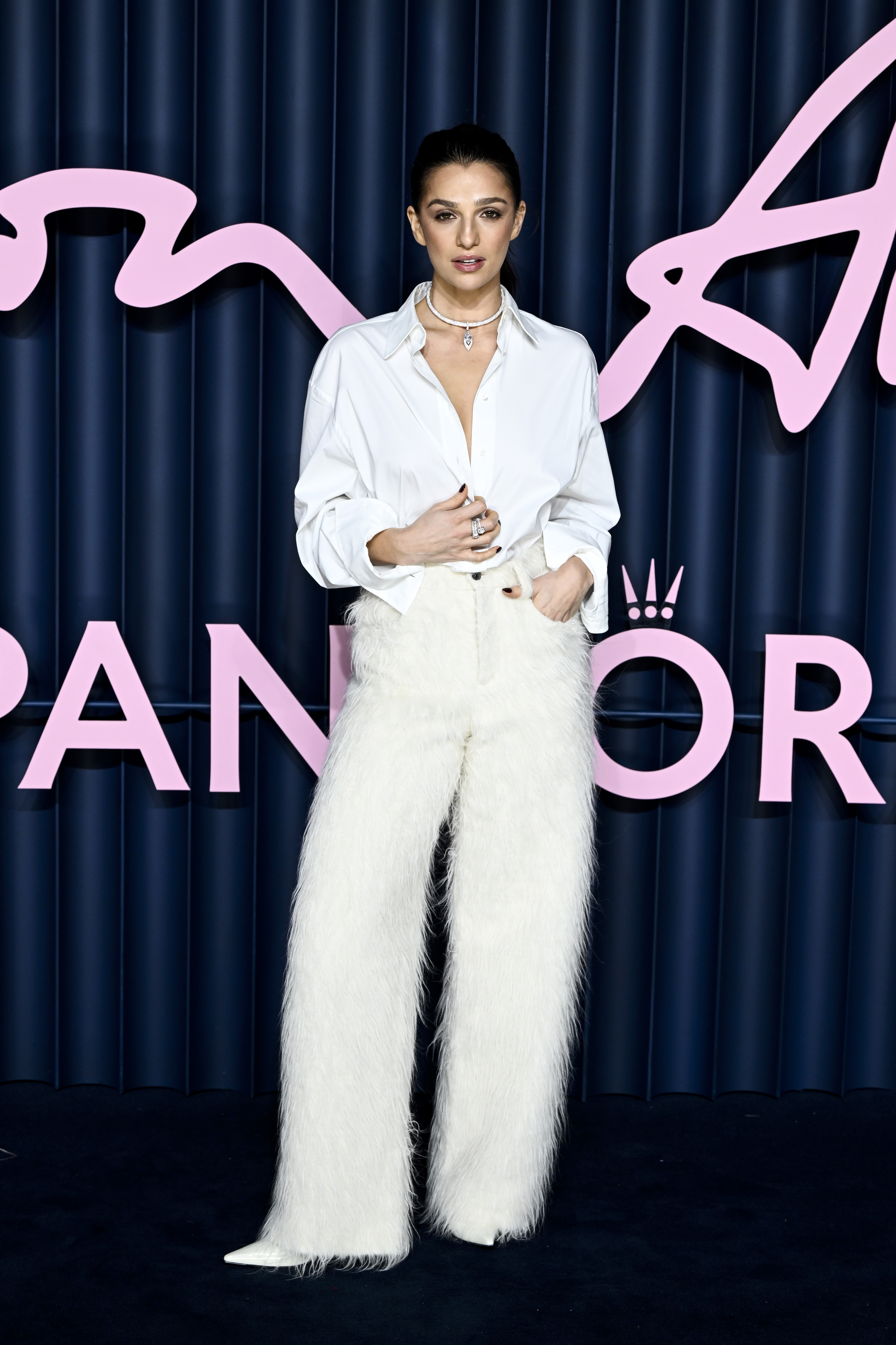 An image of Marisa Abela wearing a white shirt to the 2025 Fashion Awards.