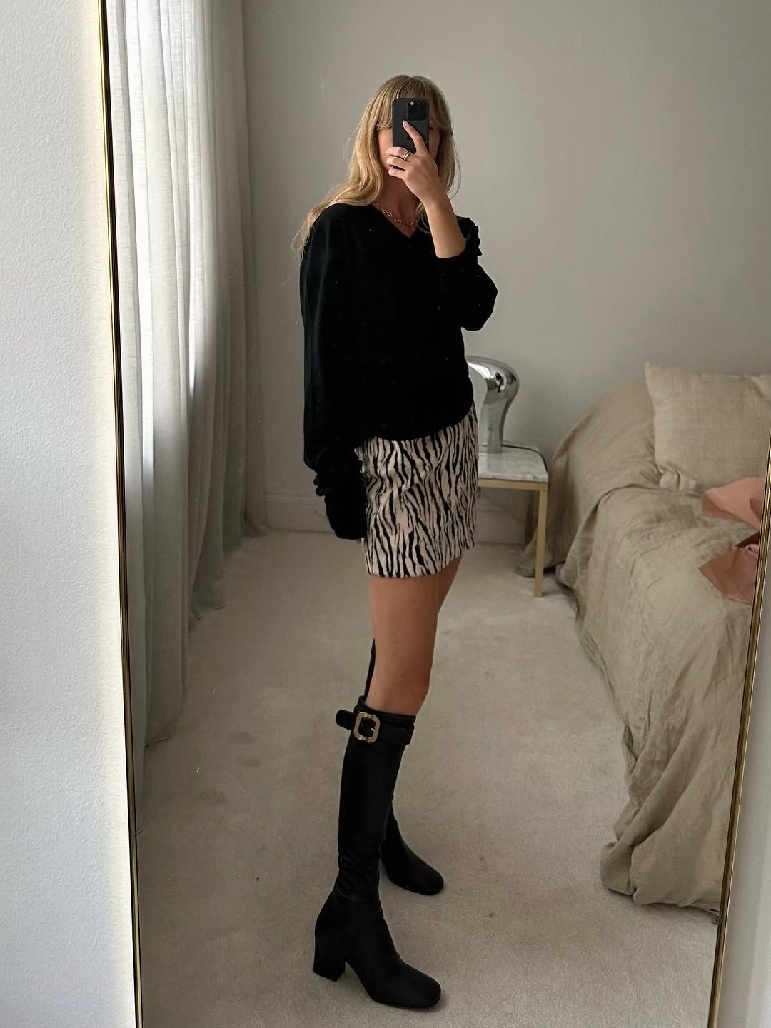 woman wearing knee high fitted boots