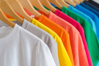 Colorful t-shirts on hangers.
