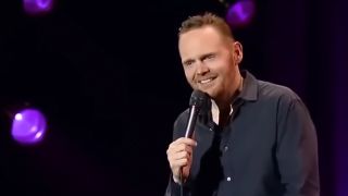 Bill Burr smiling with a microphone