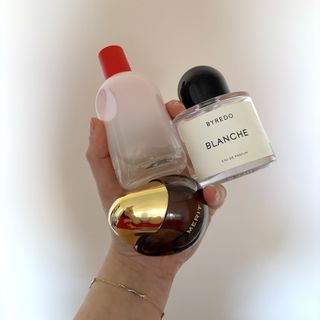 Mica Ricketts holding three of the best subtle perfumes