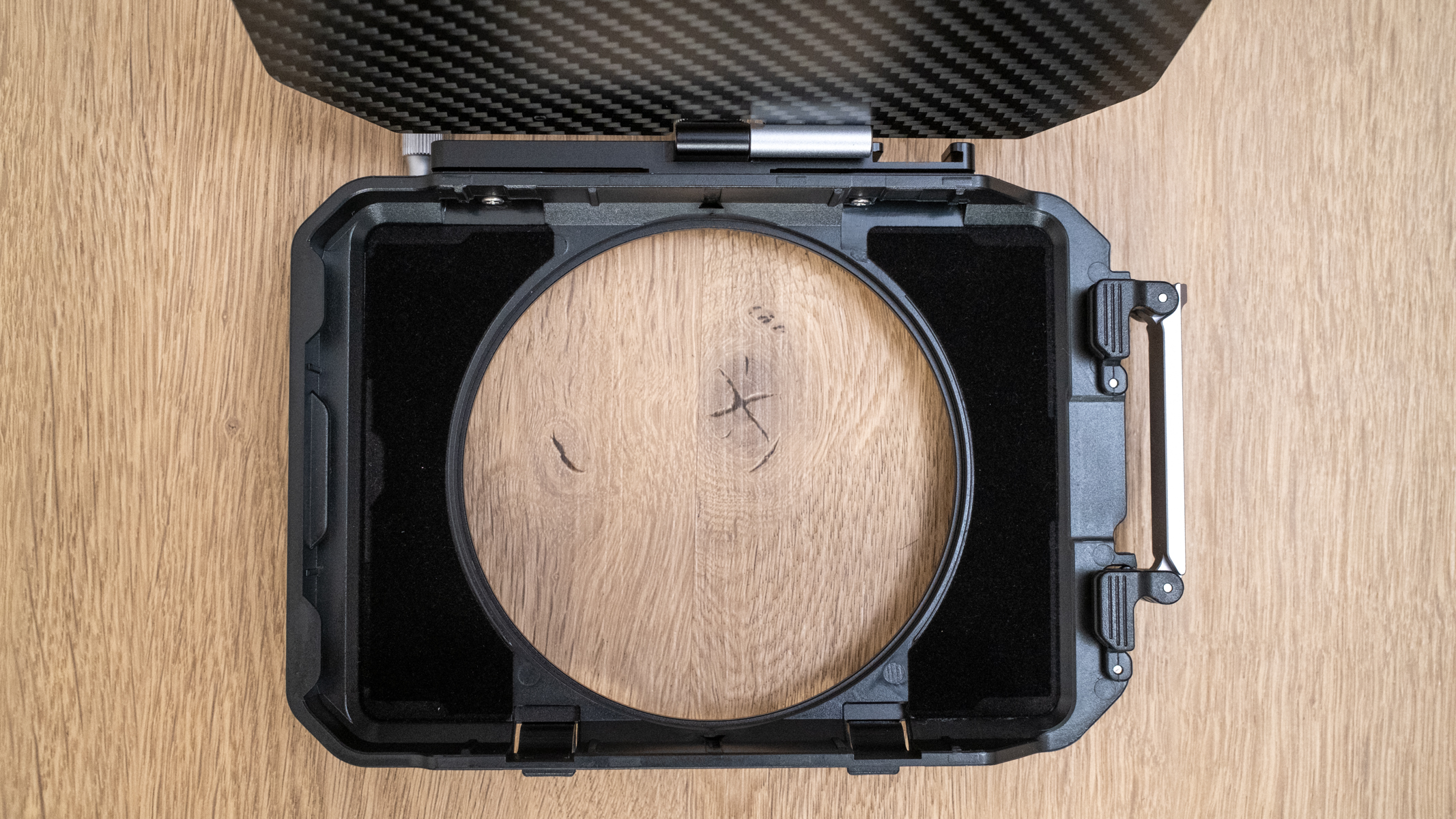 K&F Concept Matte Box laying on a wooden floor to show the matt material on the front of the matte box