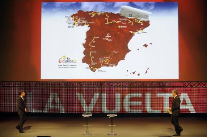 Former Spanish cyclist Perico Delgado (L) and Spanish journalist Carlos de Andres arrive on the stage during the Vuelta presentation
