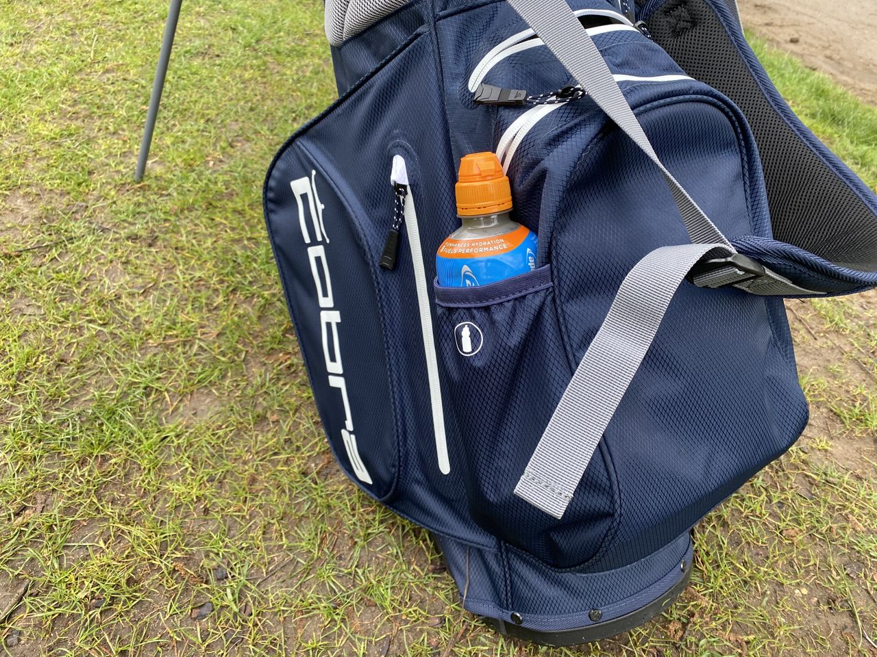 The Cobra Ultradry Pro 2023 Stand Bag with a bottle of drink in the compartment