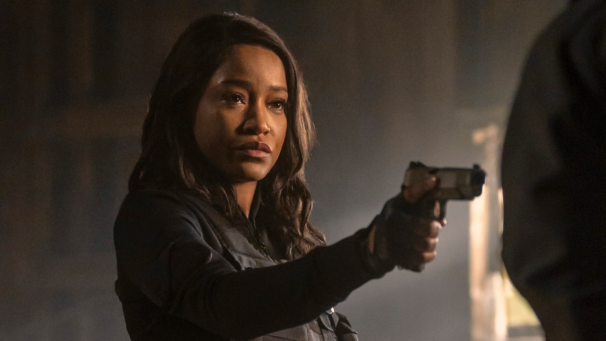 Criminal mastermind Zoe (Keke Palmer) brandishes a pistol in a scene from Prime Video's "The Pickup"