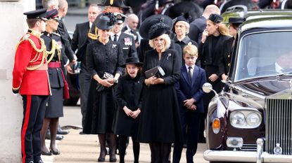 Camilla, Queen Consort, Prince George of Wales, Catherine, Princess of Wales, (obscured) Princess Charlotte of Wales and Sophie, Countess of Wessex watch the funeral procession as it passes through Wellington Arch during the state funeral of Queen Elizabeth II on September 19, 2022 in London, England. Elizabeth Alexandra Mary Windsor was born in Bruton Street, Mayfair, London on 21 April 1926. She married Prince Philip in 1947 and ascended the throne of the United Kingdom and Commonwealth on 6 February 1952 after the death of her Father, King George VI. Queen Elizabeth II died at Balmoral Castle in Scotland on September 8, 2022, and is succeeded by her eldest son, King Charles III.
