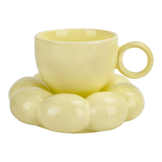 A pastel yellow cup and cloud saucer