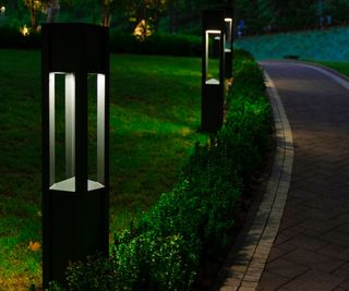 Black bollard path lights at night