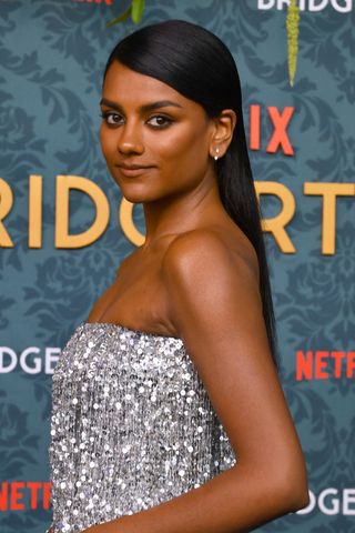 Simone Ashley is pictured with a sleek sculpted fringe look whilst arriving for Netflix's "Bridgerton Season 3" premiere at Alice Tully Hall on May 13, 2024, in New York City.