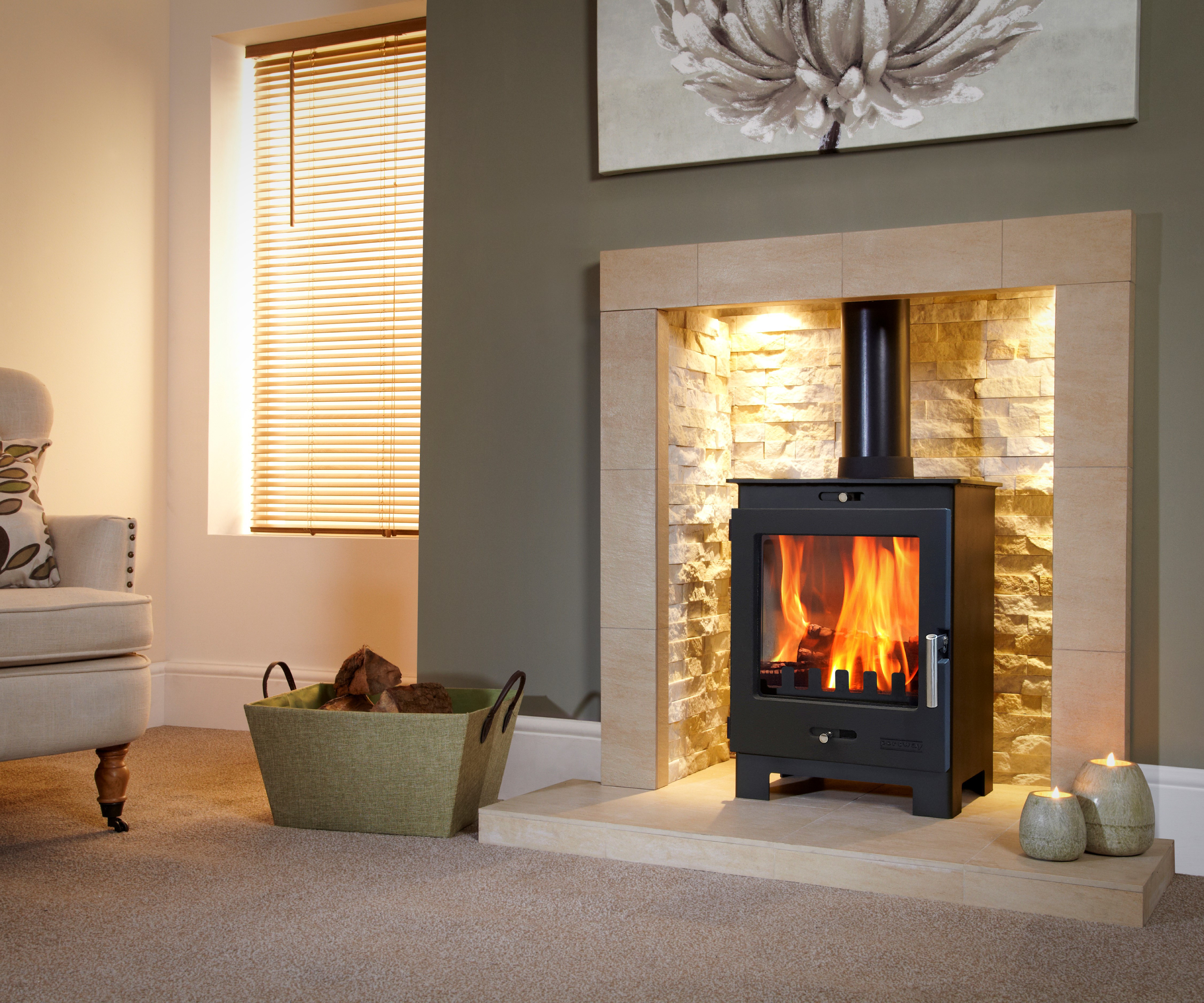 log burner inset in cream fireplace with recessed lighting