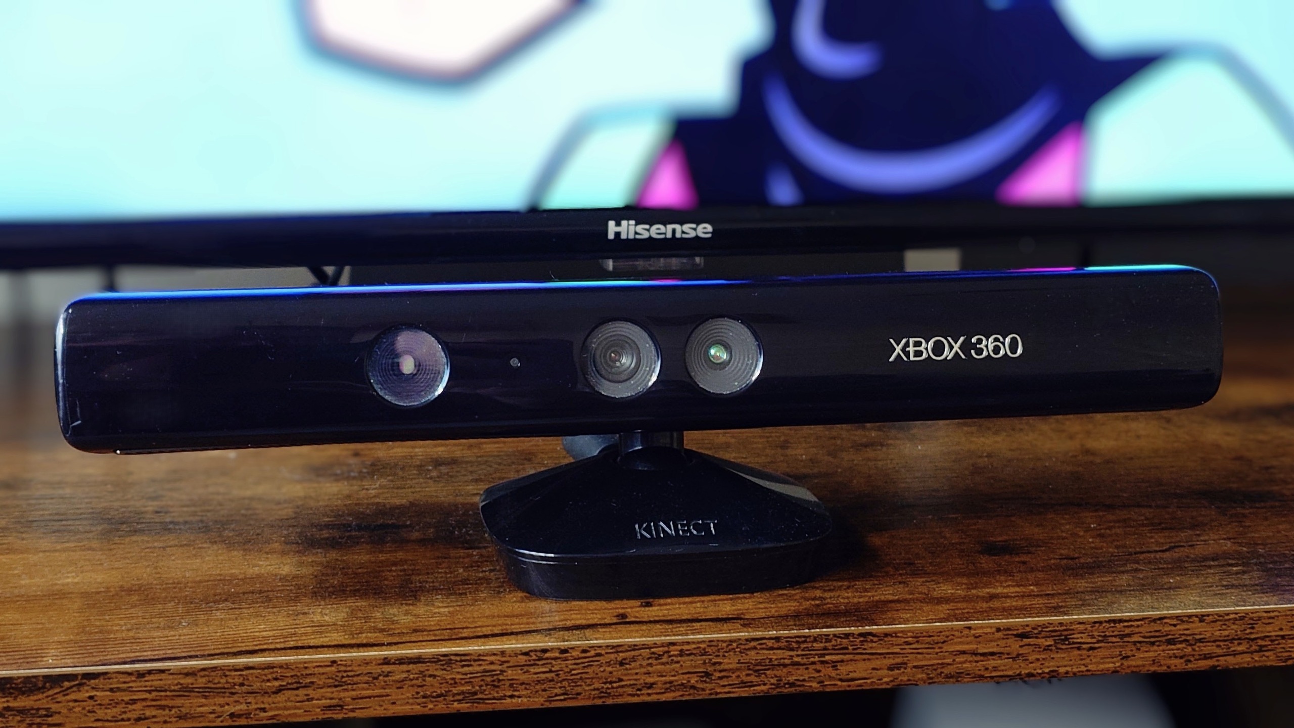A photo of an Xbox 360 Kinect unit sitting in front of a Hisense TV.