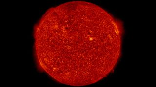 The chromosphere emits a reddish glow as super-heated hydrogen burns off.