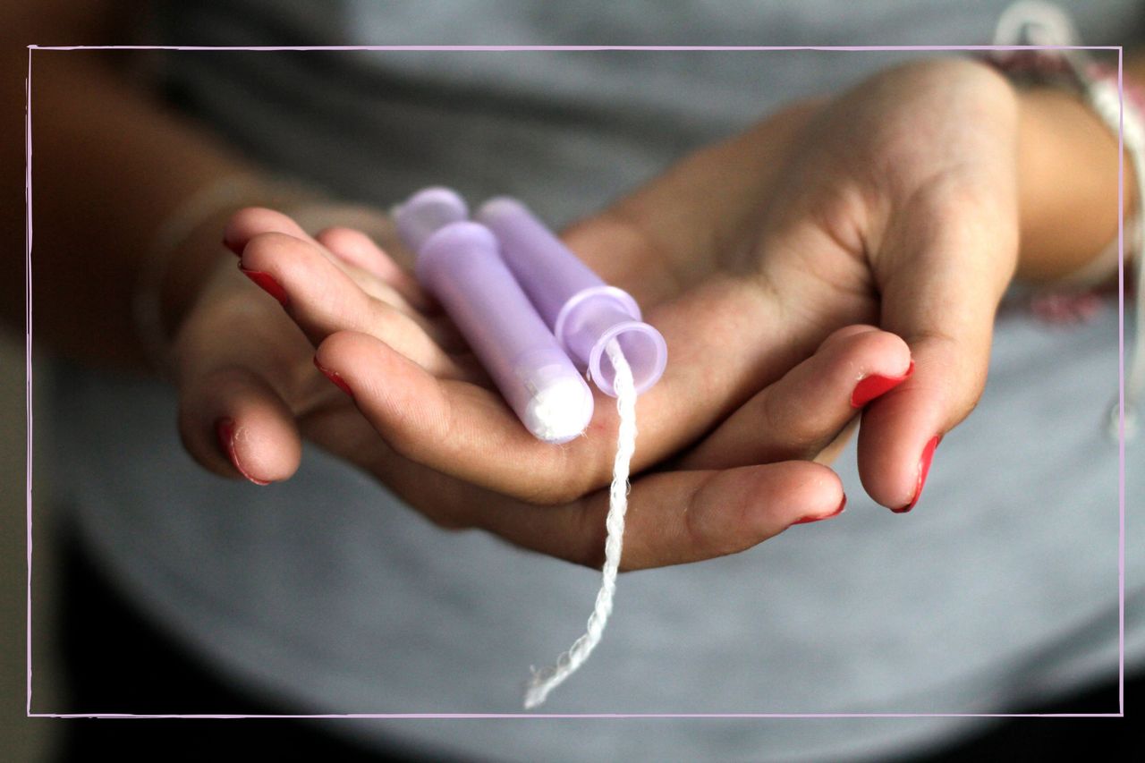 Woman holding tampons in the palms of her hands