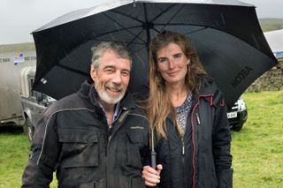 Clive Owne (left) and Amanda Owen (right) stood next to each other under an umbrella
