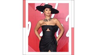 Maya Jama wears a black dress and hat as she attends The Fashion Awards 2022 at the Royal Albert Hall on December 05, 2022 in London, England.
