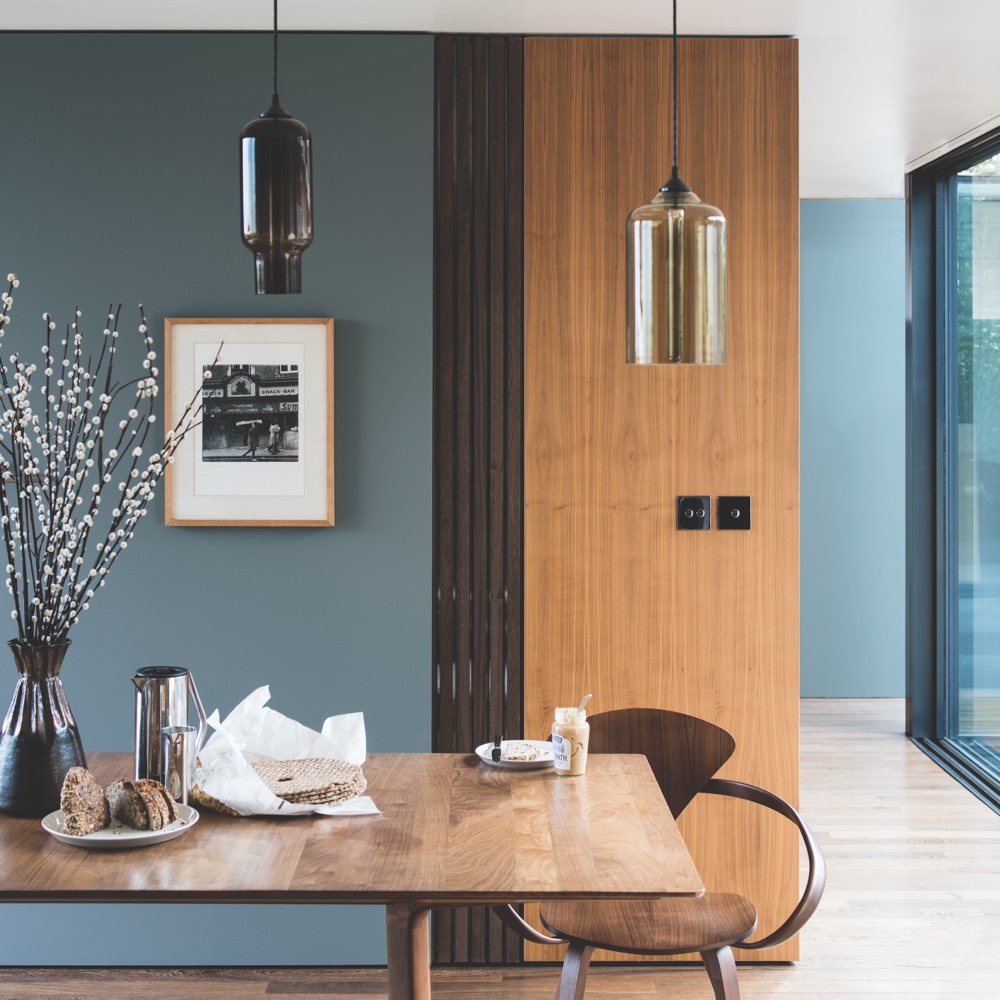 room with grey wall and wooden floor and table and chair