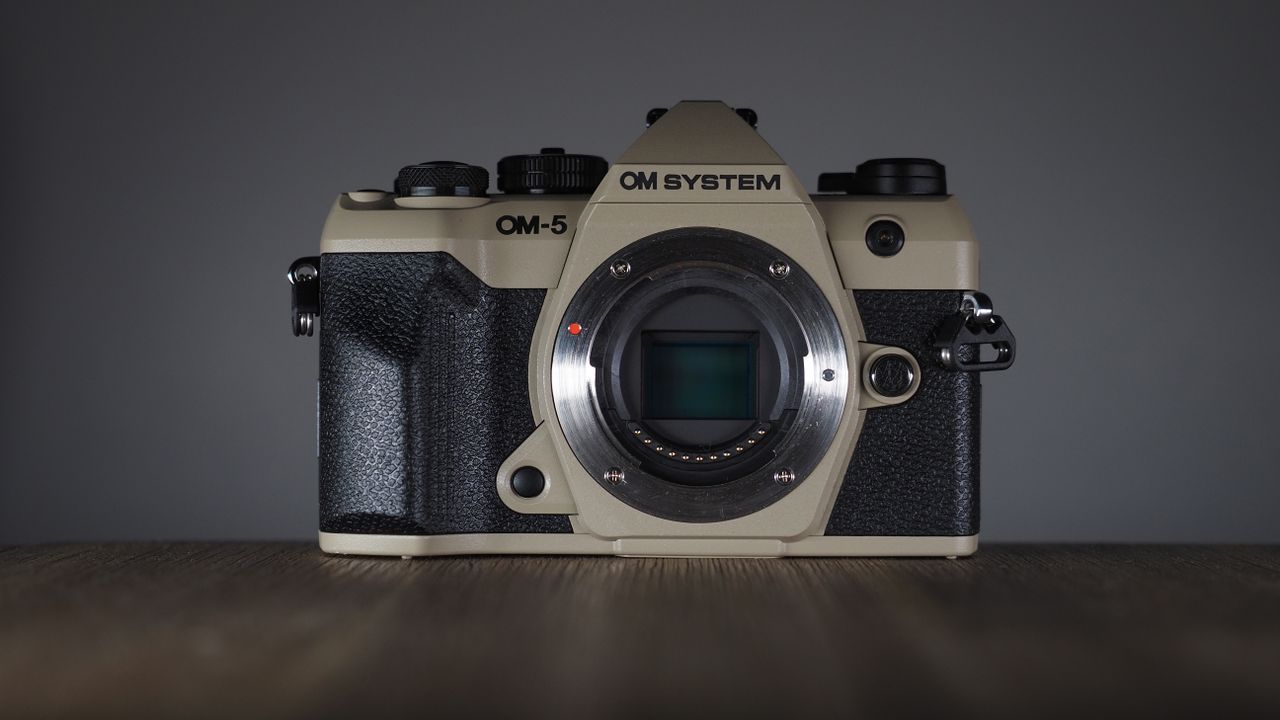OM System OM-5 Mark II on a wooden surface with an Olympus M.Zuiko 12-45mm lens