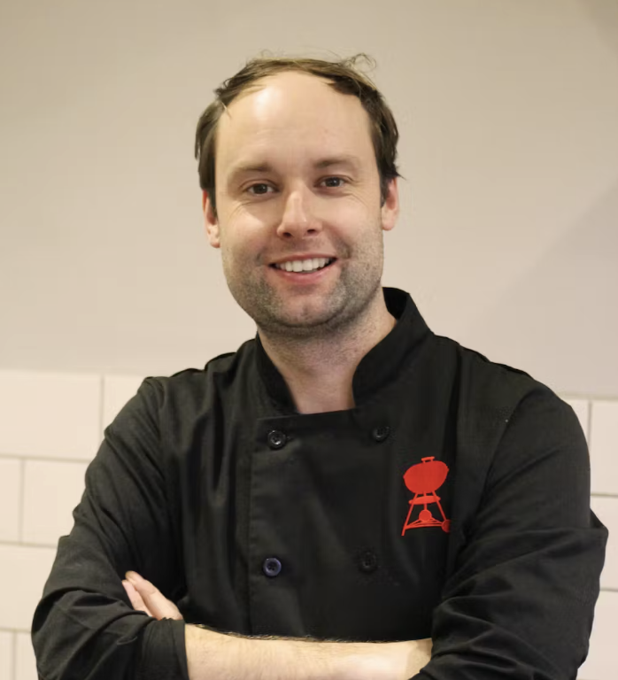 Dan Cooper wearing black chef jacket