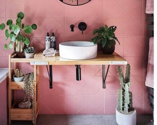 Pink bathroom with wooden shelving