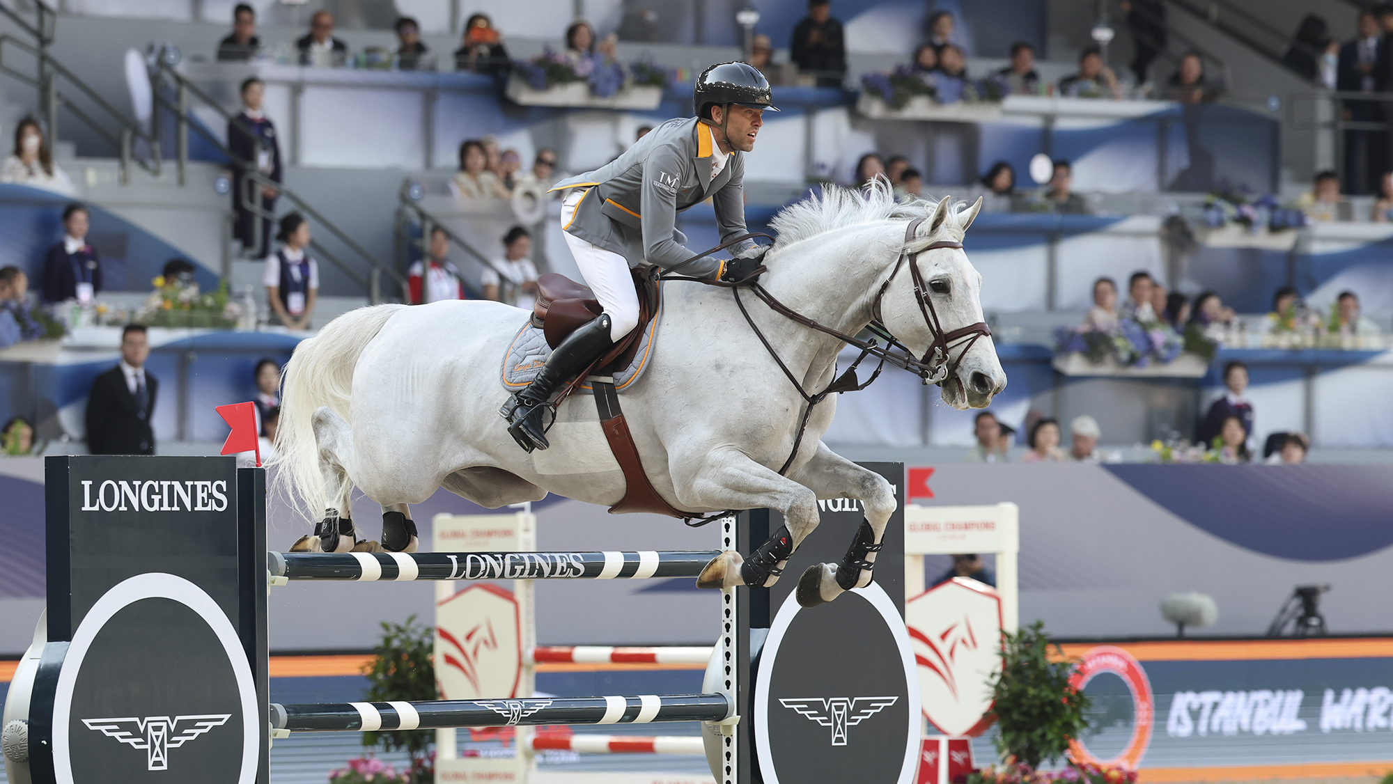 Simon Delestre jumping grey Gatsby in a GCT competition