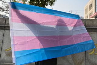 transgender pride flag this photo taken on december 3, 2019 shows transgender woman surnamed yang posing with a transgender pride flag outside the court house in hangzhou earlier this year, shortly after completing gender reassignment surgery, a chinese transgender woman surnamed yang was fired from her job, an all too common fate for members of the countrys lgbt community the reason given for her dismissal was chronic tardiness, but yang smelled a rat and sued her former employer in what lgbt activists are calling a landmark test of a transgender seeking redress through a new addition to chinese law promoting equal employment rights photo by hector retamal afp to go with afp story china justice transgender homosexuality,focus by kelly wang photo by hector retamalafp via getty images