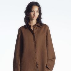 Woman wears brown linen shirt
