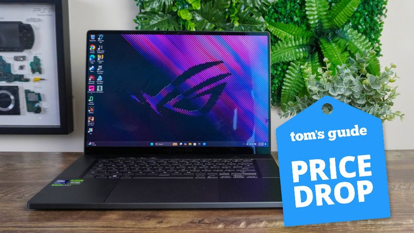 Asus ROG Zephyrus G16 on table with Tom&#039;s Guide Price Drop badge