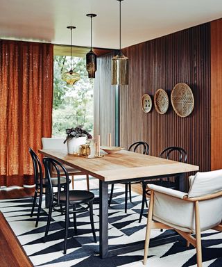 Dining room with wooden chairs, table and patterned rug
