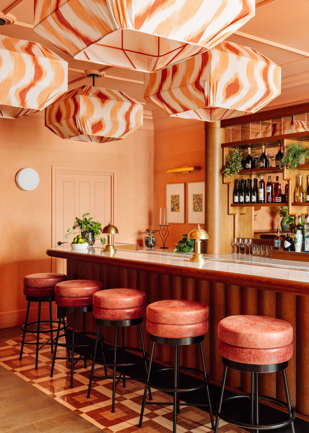 A brightly decorated, patterns and plush textiles-filled hotel's rooms and common spaces feature an earthy palette ranging from ochre and green to terracotta, orange, and brown.