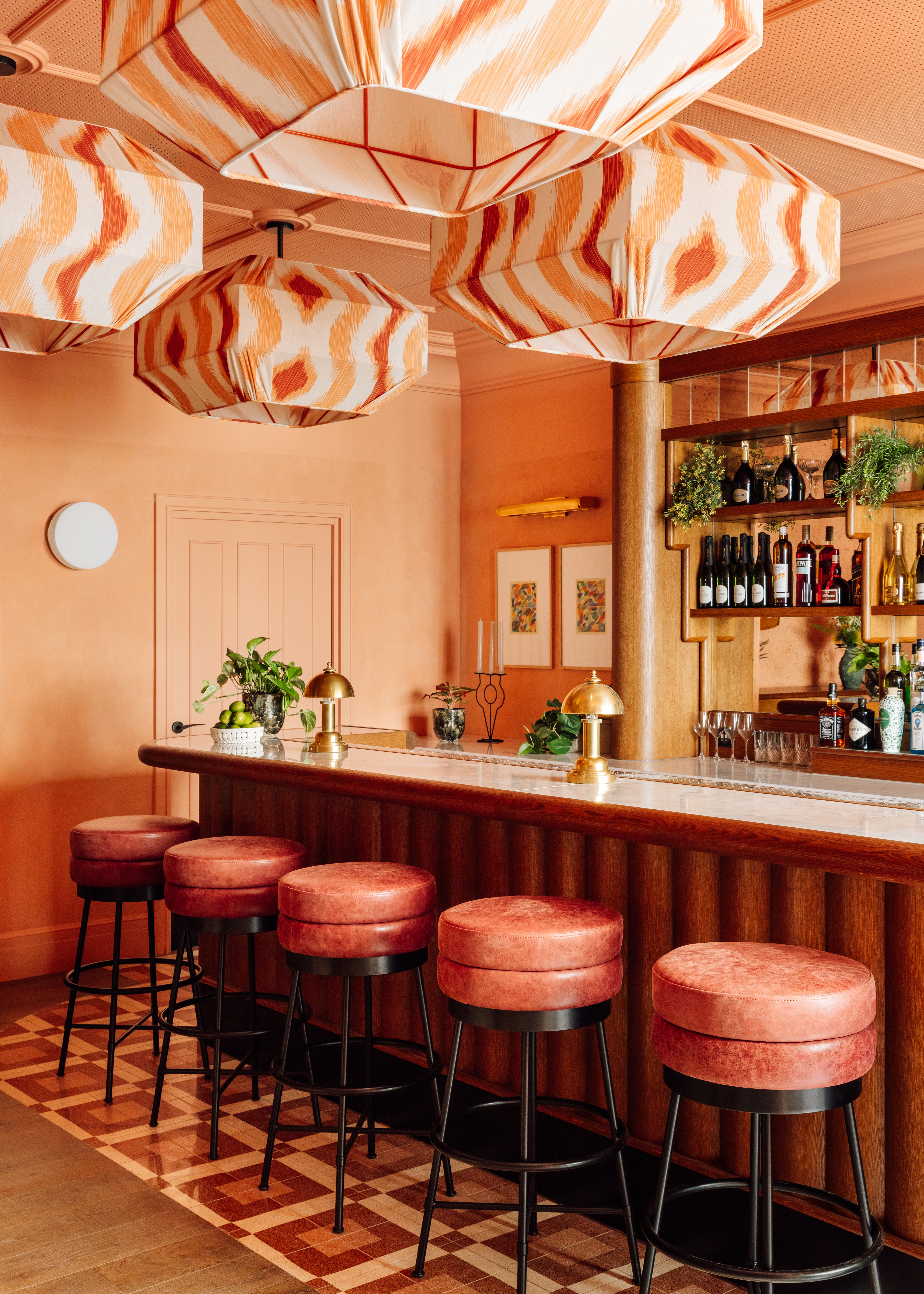 A brightly decorated, patterns and plush textiles-filled hotel's rooms and common spaces feature an earthy palette ranging from ochre and green to terracotta, orange, and brown.