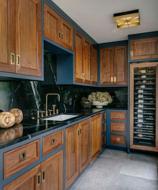 Wooden kitchen with navy blue painted accents