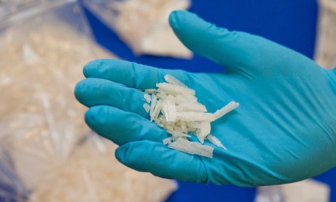 A German customs officer holds confiscated amounts of the drug crystal meth. 