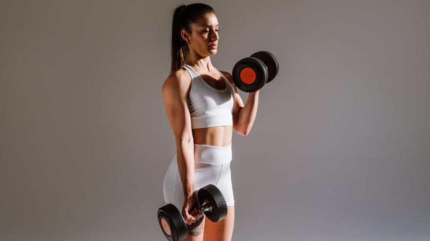 a woman holding a dumbbell in either hand