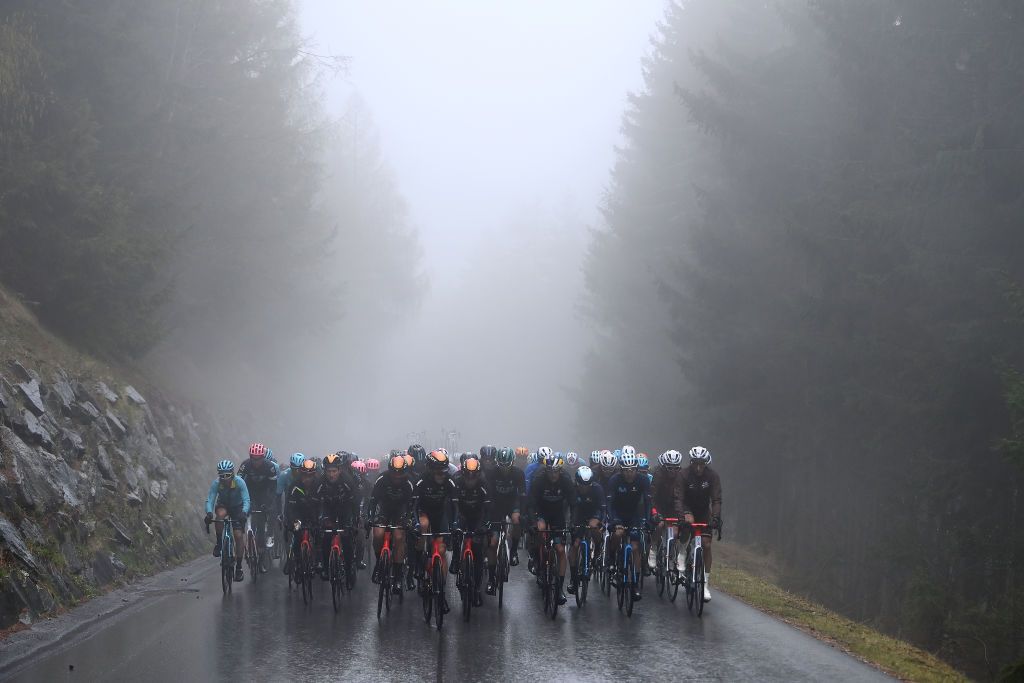 LIENZ AUSTRIA APRIL 22 Pello Bilbao Lpez De Armentia of Spain and Team Bahrain Victorious Green Leader Jersey with teammates lead the peloton passing through a forest landscape with rainy and foggy conditions during the 45th Tour of the Alps 2022 Stage 5 a 1145km stage from Lienz to Lienz TouroftheAlps on April 22 2022 in Lienz Austria Photo by Tim de WaeleGetty Images