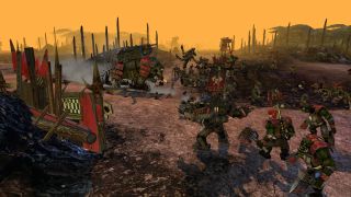 A squiggoth rampages through an ork encampment