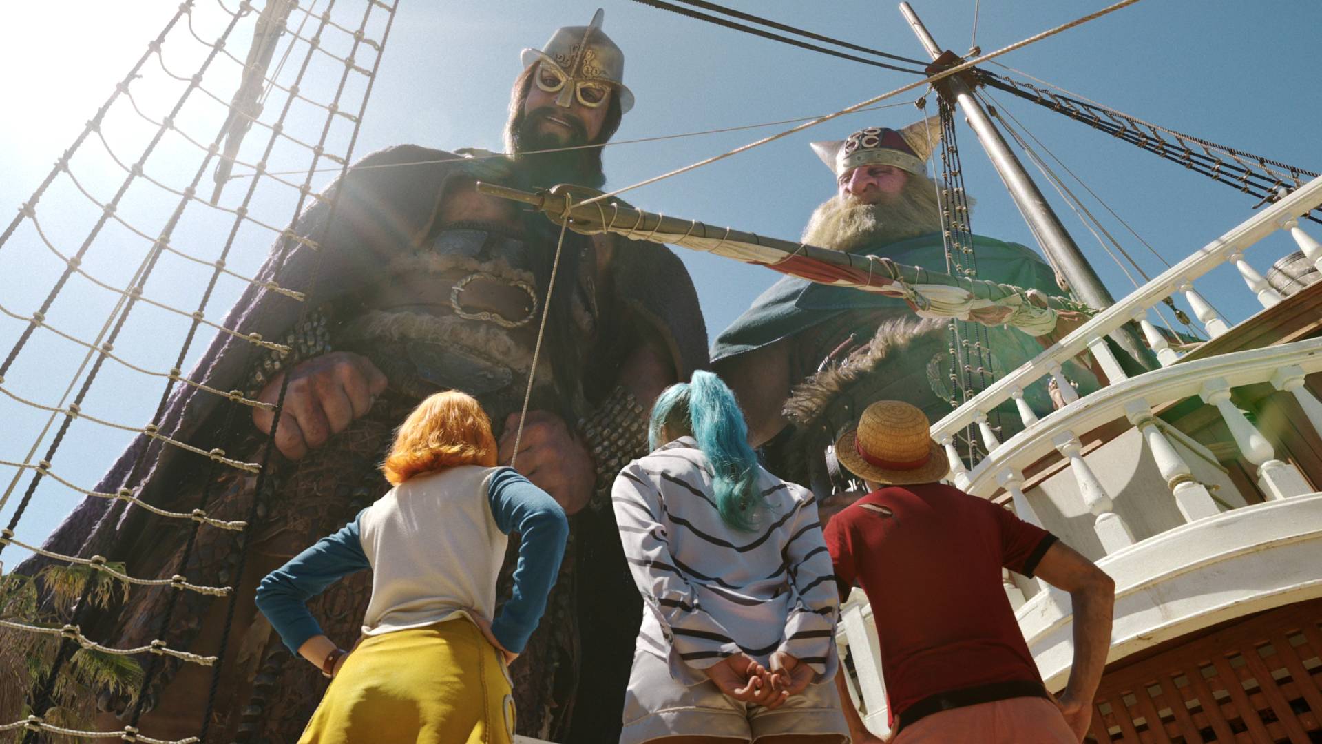 Monkey D. Luffy (I&amp;ntilde;aki Godoy), Nami (Emily Rudd) and Miss Wednesday (Charithra Chandran) looking up at the giants Brogy and Dory