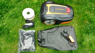 Lawnmaster L10 robot mower and accessories on lawn