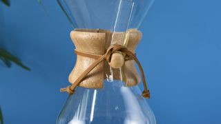 an hourglass coffee maker by Chemex with a 6 cup capacity and a wooden collar with a rawhide tie