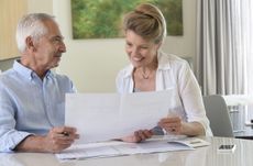 Senior couple doing paperwork at home