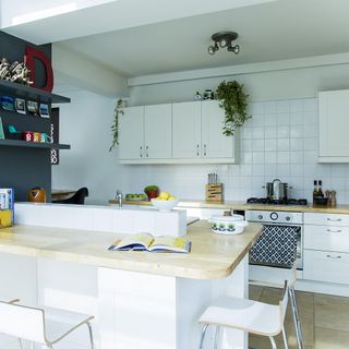 kitchen with white wall and counter wooden on top