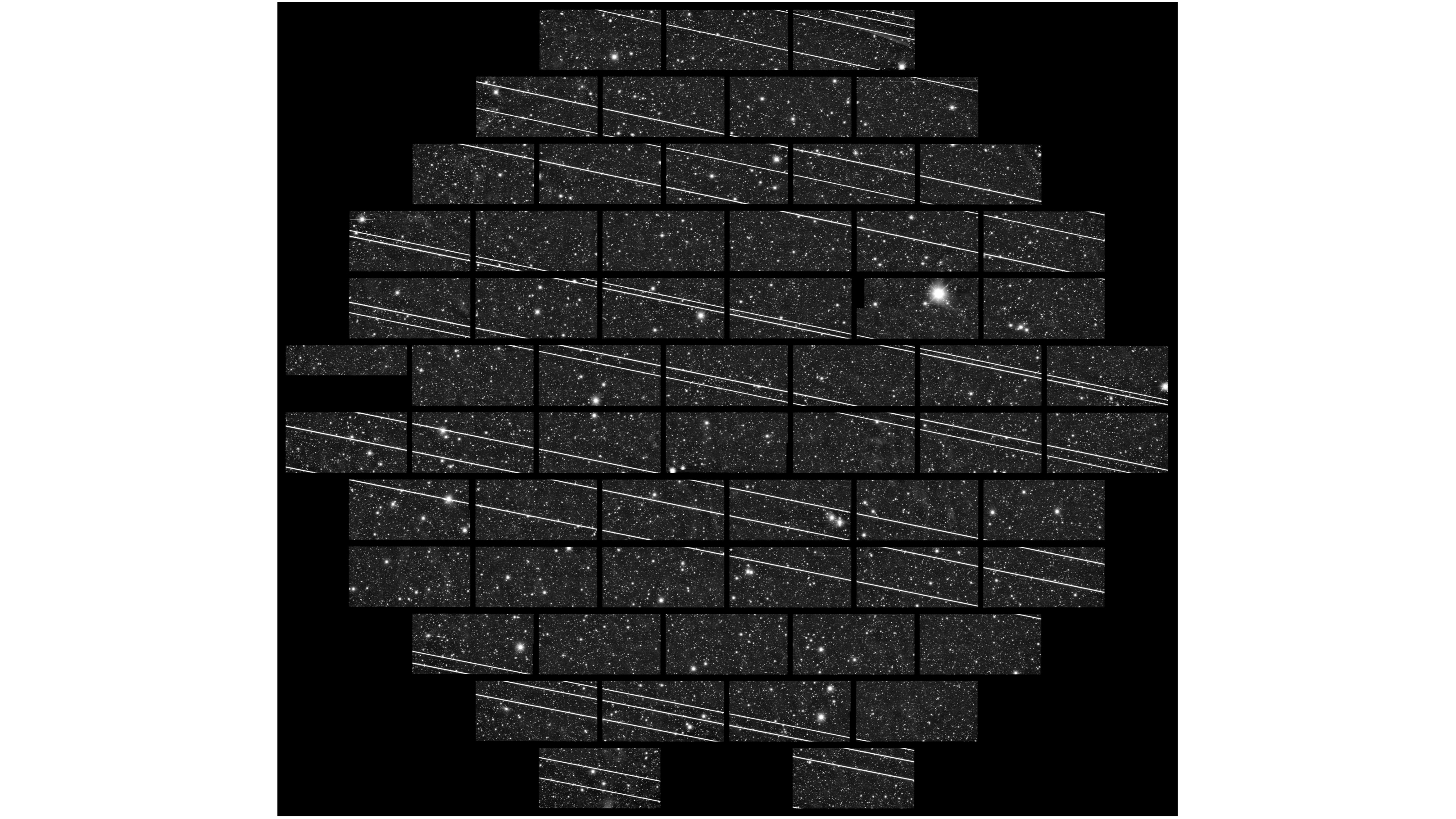 photo of a telescope's field of view on the night sky, showing white streaks running through several dozen rectangular boxes