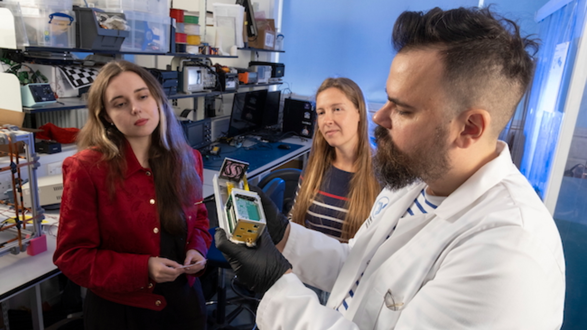 An experiment using different colored bacteria with the camera focused on a metal box containing the bacteria