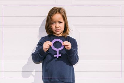 A girl holding a purple women symbol