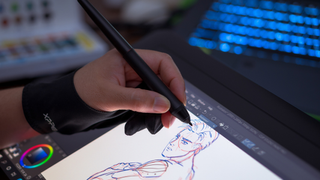 Close-up of an artist using Photoshop and stylus on a tablet