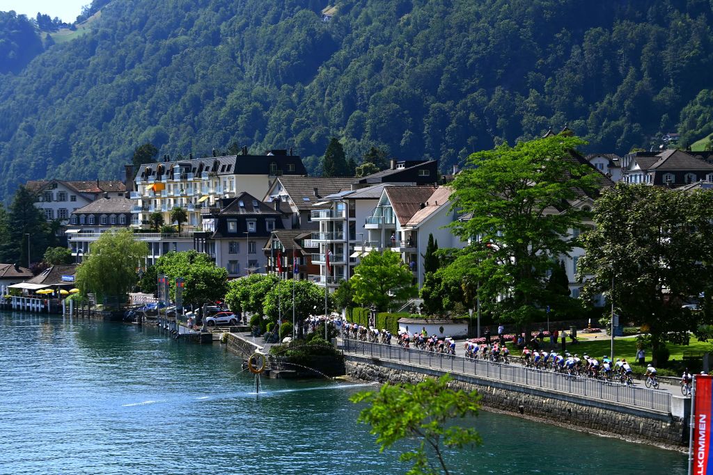 BRUNNEN SWITZERLAND JUNE 15 A general view of the peloton compete passing through lake Lucerna in the village of Ingenbohl during the 85th Tour de Suisse 2022 Stage 4 a 1908km stage from Grenchen to Brunnen ourdesuisse2022 WorldTour on June 15 2022 in Brunnen Switzerland Photo by Tim de WaeleGetty Images