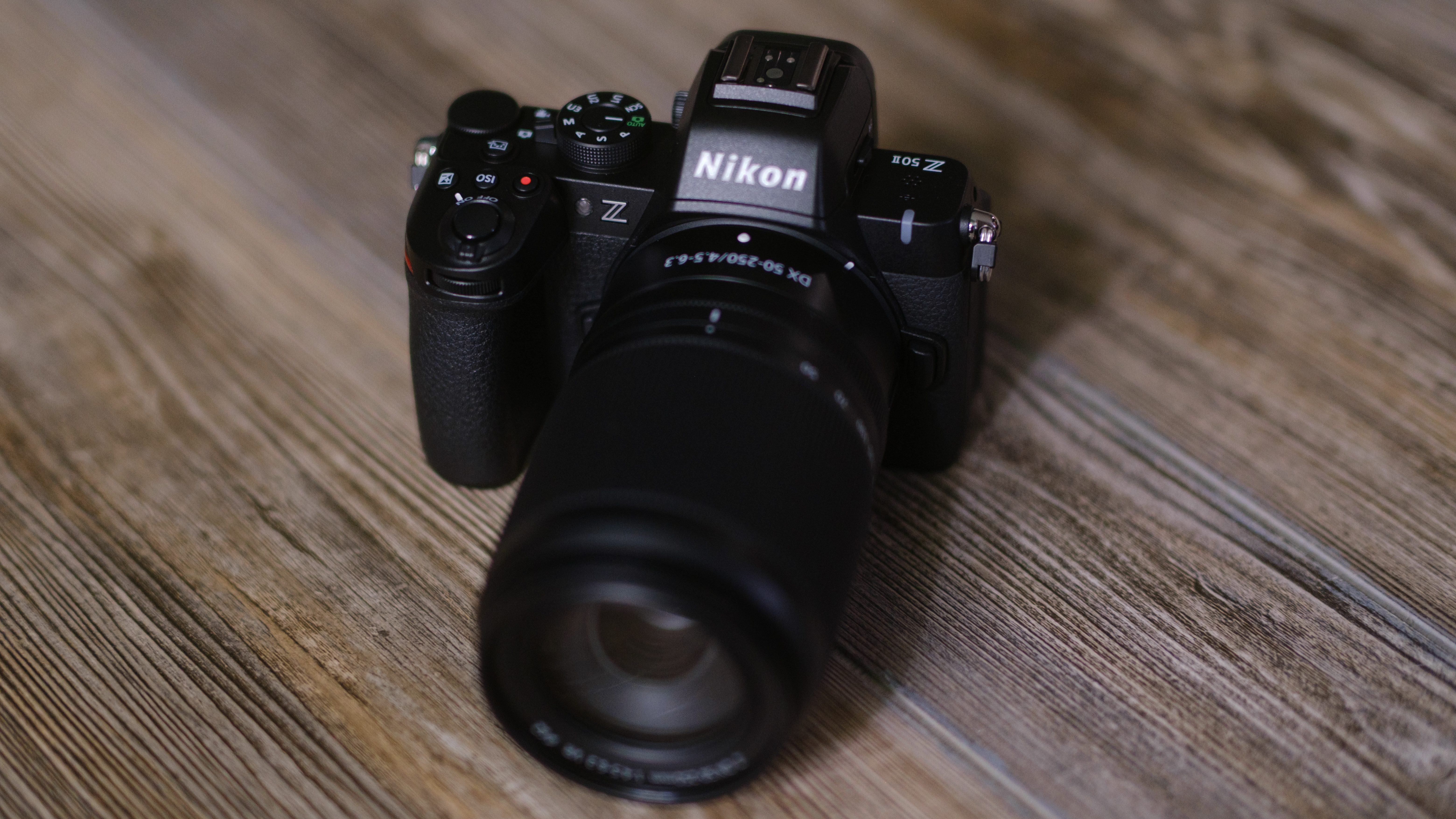 The Nikon Z50 II on a wood surface
